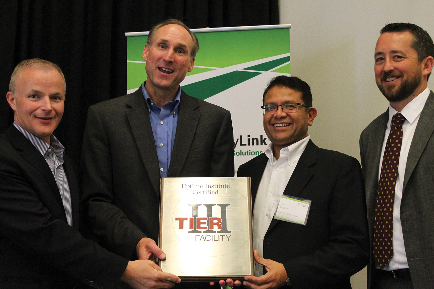 CenturyLink executives (left to right) Joel Stone, Drew Leonard, and Ash Mathur accept the plaque for CenturyLink’s new Tier III Certified Facility in Toronto from Uptime Institute Chief Operating Officer Julian Kudritzki.